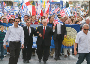 A Christians United for Israel (CUFI) solidarity march in Jerusalem in 2010. In center in front of the banner, holding American and Israeli flags, is CUFI founder Pastor John Hagee. Photo: CUFI.