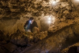 An Israel Antiquities Authority (IAA) worker excavates in a Judean Desert cave. Photo: Yuli Schwartz/IAA.