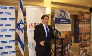 Israeli Ambassador to the UN Danny Danon in front of the controversial panels now on display at the UN. Photo; Twitter.