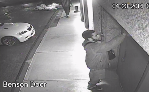 A screenshot of footage showing the suspect spraying antisemitic graffiti on a building in Tribeca. Photo: Screenshot.