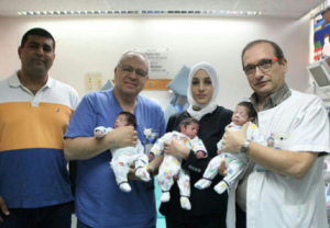 Hadaya Badran, second from the left, flanked by her doctors holding her triplets. Her husband is at the far left. Photo: Courtesy of the family.
