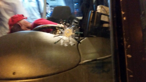 The bullet struck the bus window directly in front of the driver. 