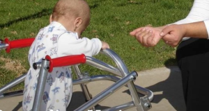 A disabled toddler being helped by an ALEH professional. Photo: ALEH website.
