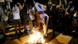 Protesters burning the Israeli flag outside the Democratic National Convention. Photo: Twitter/United With Israel.