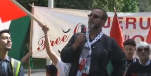 Ali Mallah - seen here addressing Toronto's 2016 Al-Quds Day rally - called for Israelis to be shot and for Palestinians to attack Israel by "any means necessary." Photo: Video Screenshot.