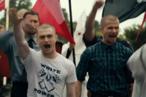 Actor Daniel Radcliffe, left, doing the Nazi salute in a scene from "Imperium." The film comes out Aug. 19. Photo: Screenshot.