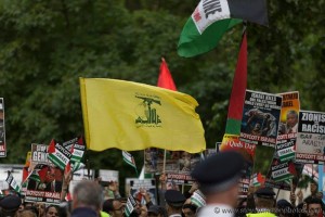 Hezbollah flag being flown during 2016's Al-Quds Day march in London. Photo: Steve Winston. 