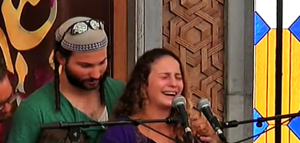 Yehoshua and Orit Mark eulogizing their father, Rabbi Michael Mark, at his funeral on Sunday. Photo: Channel 2/Screenshot.