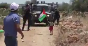 A Palestinian father pushing his toddler son to provoke Israeli Border Police into shooting him. Photo: Screenshot.