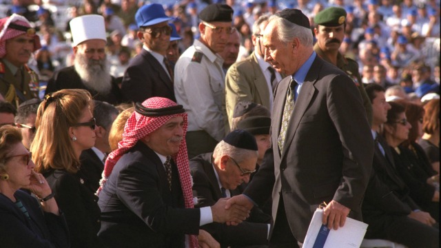 The late Shimon Peres shakes hands with Jordan's King Hussein at the funeral of Yitzhak Rabin on Mount Herzl in Jerusalem in November 1995. Photo: Moshe Milner via Wikimedia Commons.