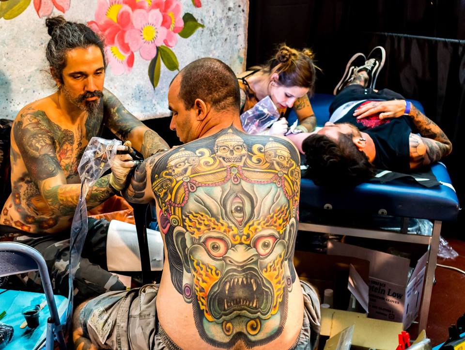 Tattoo artists inking attendees of the 2016 Israel Tattoo Convention. Photo: Facebook.