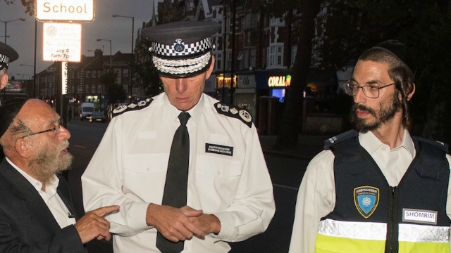 Shomrim volunteers speak with a London police officer. Photo: Campaign Against Antisemitism website.