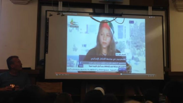 Bassem Tamimi (on left) seen playing an anti-Israel video during a presentation to third-graders at an Ithaca elementary school. Photo: Video screenshot.