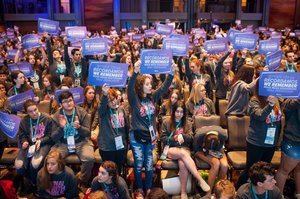 Delegates hold signs stating “We Remember” in five languages at the BBYO International Convention’s Friday morning plenary session Feb. 17. Photo: Jason Dixson Photography.
